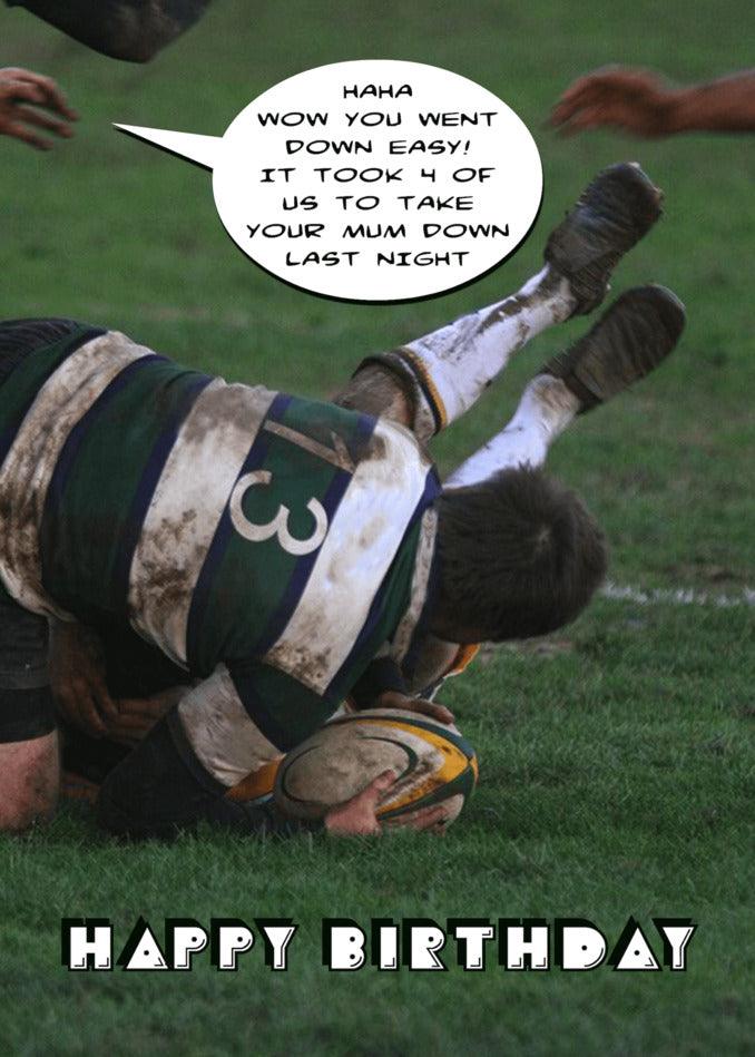 A player is laying on the ground while a rugby fan chuckles nearby, holding the Twisted Gifts Down Easy Rude Birthday Card.