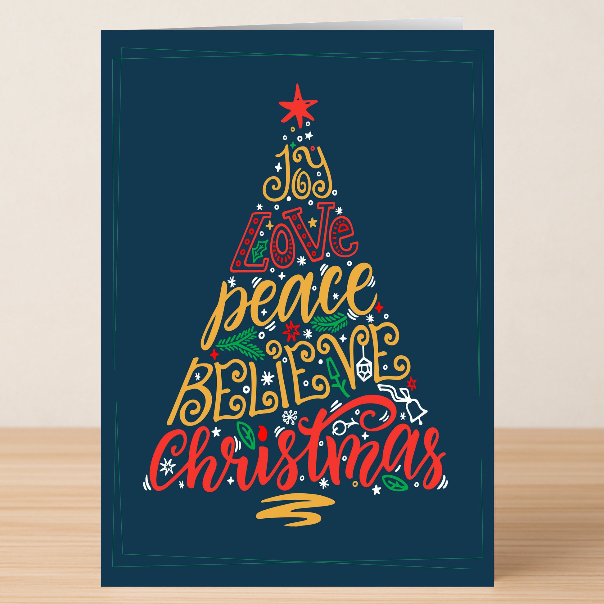 Share festive wishes with Twisted Gifts' Joy Tree Christmas Card, featuring a tree design shaped by "joy, love, peace, believe, Christmas" in vibrant text on a dark blue background—ideal for holiday celebrations.