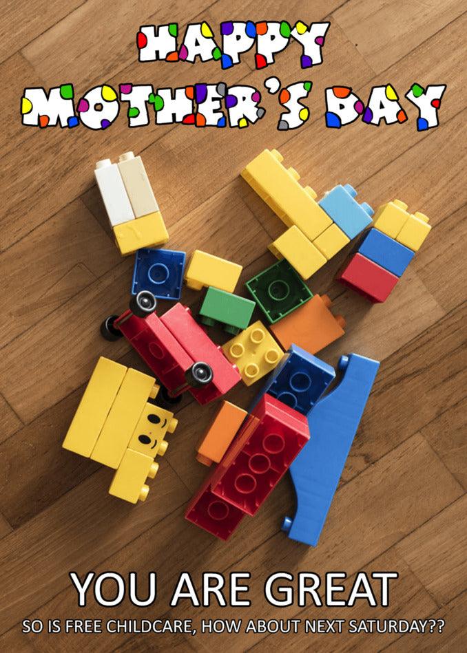 A pile of Free Childcare Funny Mother's Day Card-type colorful building blocks on a wood floor, by Twisted Gifts.