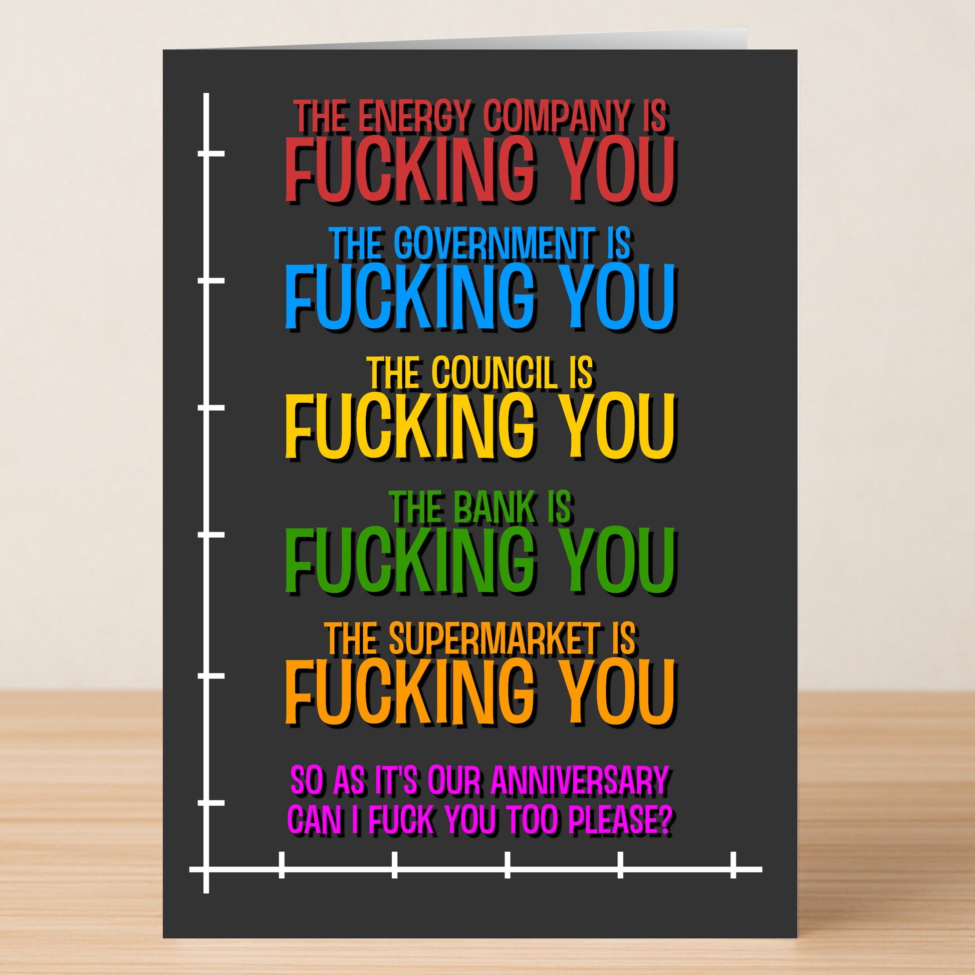The Energy Company Funny Anniversary Card by Twisted Gifts features bold, colorful text listing energy companies “fucking you”—ending with a cheeky anniversary wish. Perfect for couples who appreciate edgy humor, all on a sleek dark background.