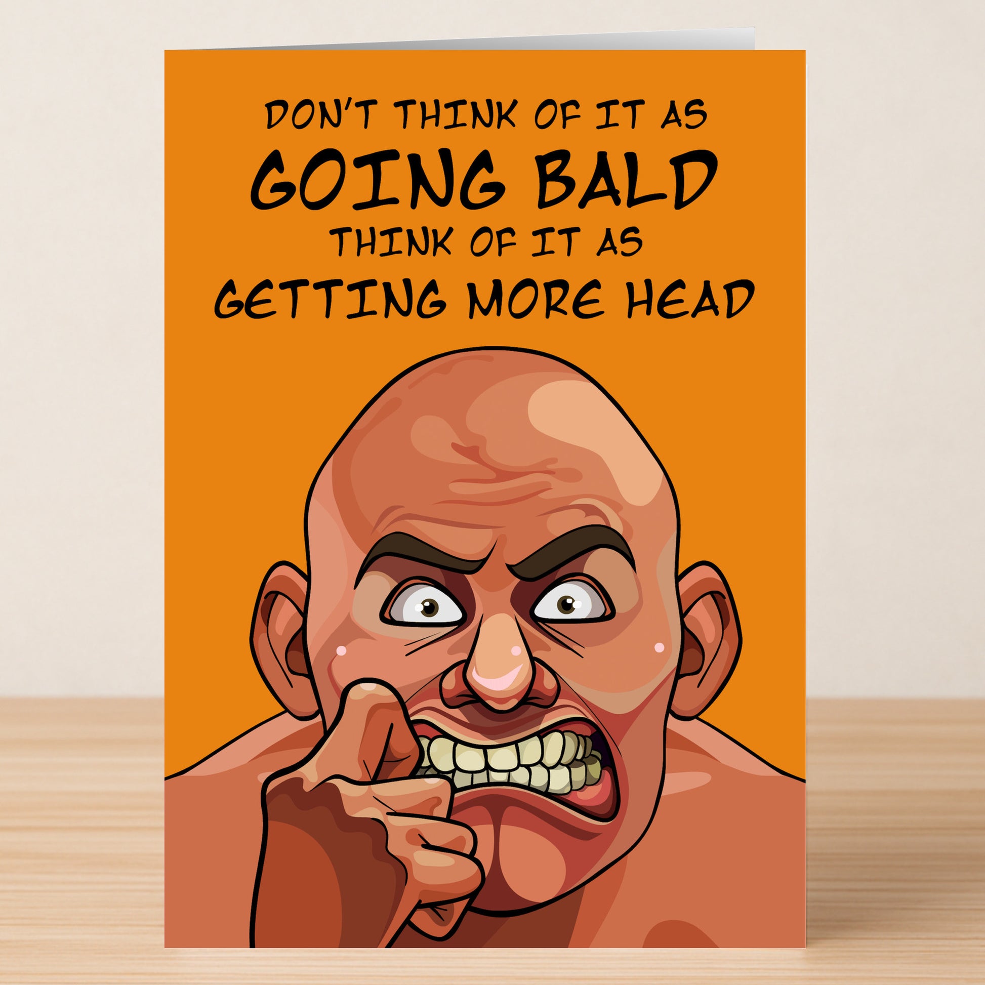The More Head Rude Greeting Card by Twisted Gifts features a creative cartoon of a bald, angry man biting his finger with the text: "Don't think of it as going bald, think of it as getting more head." A funny card for lovers of humor.