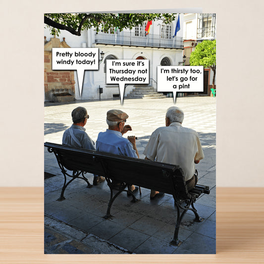 The Windy Thursday Funny Greeting Card by Twisted Gifts shows three elderly men on a sunny bench, cracking jokes about the weather and wishing for a drink—perfect for sending laughs to friends.