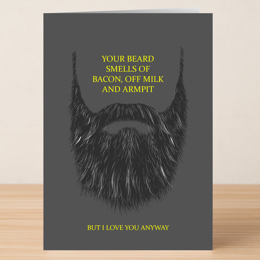 The Twisted Gifts Beard Funny Greeting Card features a thick black beard and bold yellow text: "Your beard smells of bacon, off milk and armpit. But I love you anyway"—a humorous card for any fun occasion.