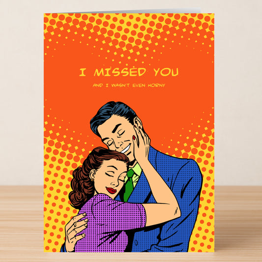 The Horny Rude Greeting Card by Twisted Gifts features a retro comic-style couple embracing with the text "I MISSED YOU AND I WASN'T EVEN HORNY" on an orange dotted background—a hilarious card for anyone with a cheeky sense of humor!.