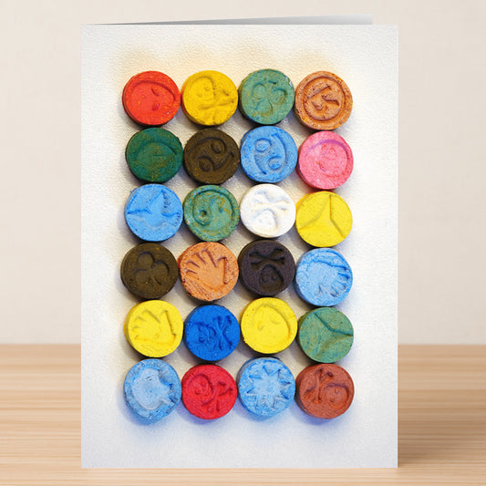 A grid of colorful, round tablets, each with a unique imprint—resembling the clever punchlines found on the Twisted Gifts Party Time Funny Greeting Card.