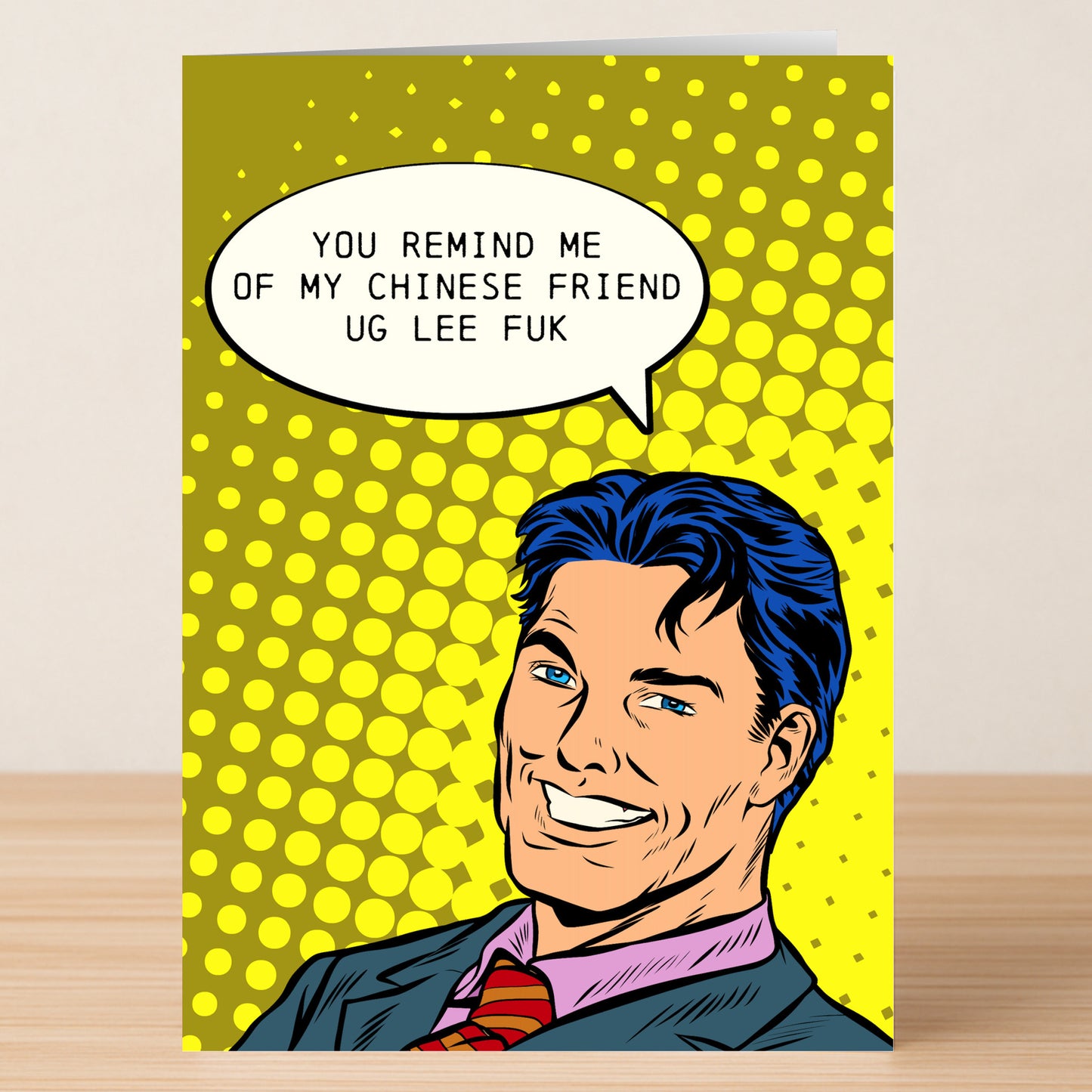 The Chinese Friend Insulting Greeting Card by Twisted Gifts features a cartoon man in a suit with a humorous speech bubble on a bright yellow dotted background—perfect for anyone who loves unique, funny cards.