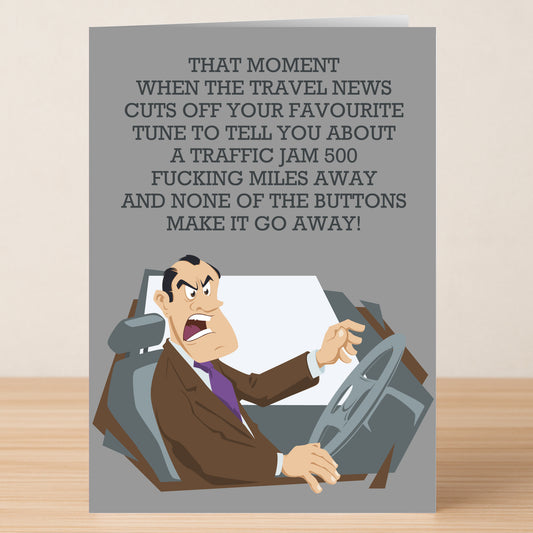 The Travel News Funny Greeting Card by Twisted Gifts shows a cartoon man in a suit, annoyed while driving. The card says: "That moment when the travel news cuts off your favourite tune to report a traffic jam 500 miles away...