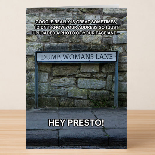 The Dumb Woman Funny Greeting Card by Twisted Gifts features a "Dumb Woman's Lane" street sign on stone and witty Google address text—a hilarious choice for anyone with a quirky sense of humor.