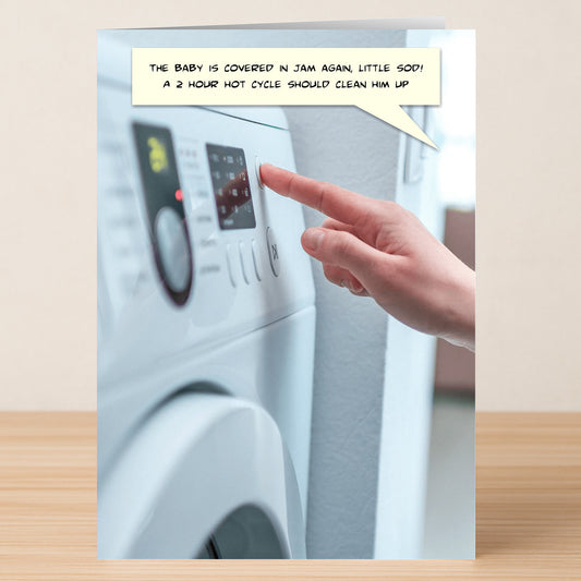 A hand presses a washing machine button while a speech bubble says, “The baby’s covered in jam again! A 2 hour hot cycle should clean him up.” Hot Cycle Funny Greeting Card by Twisted Gifts – perfect for witty greetings.