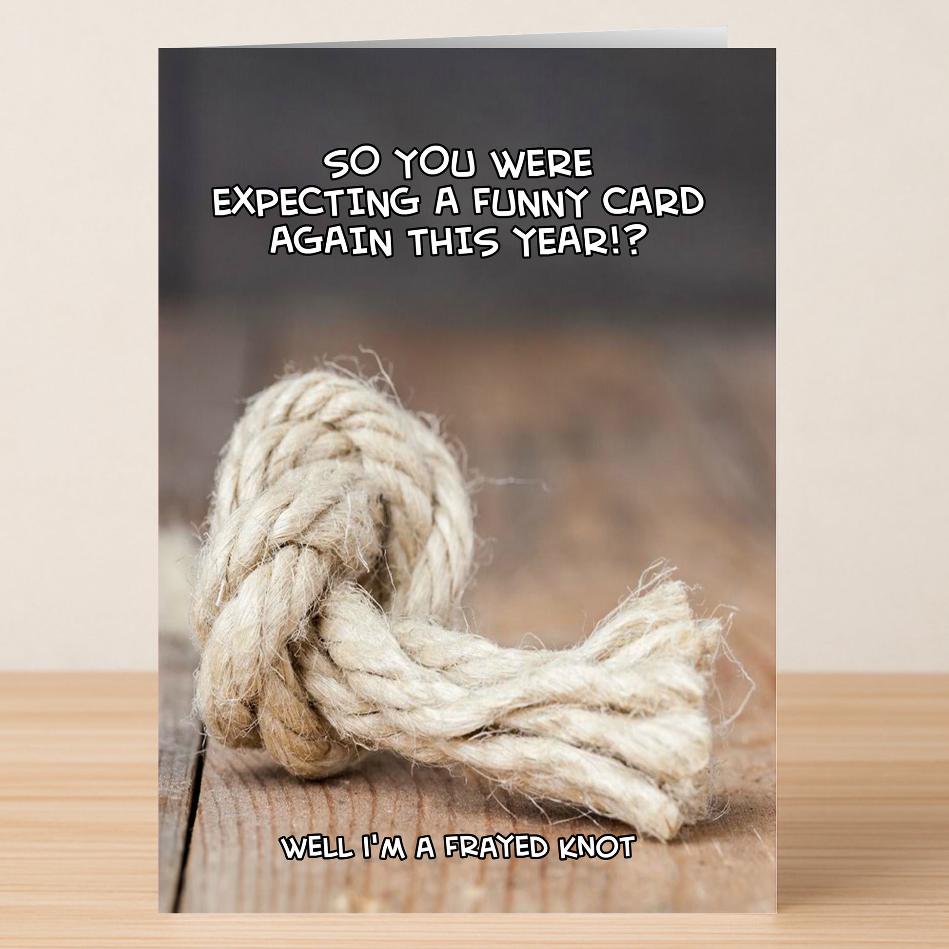 The Frayed Knot Funny Greeting Card by Twisted Gifts features a photo of a frayed knot on wood and the witty text, "SO YOU WERE EXPECTING A FUNNY CARD AGAIN THIS YEAR!? WELL I'M A FRAYED KNOT," crafted from quality materials.