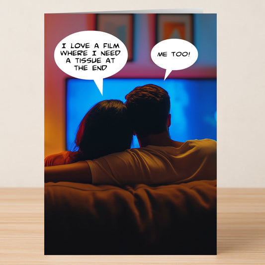 A couple snuggles up watching TV on the "Love A Film" Rude Greeting Card by Twisted Gifts, playfully bantering with speech bubbles: "I love a film where I need a tissue at the end" and "Me too!"—perfect for fun greetings.