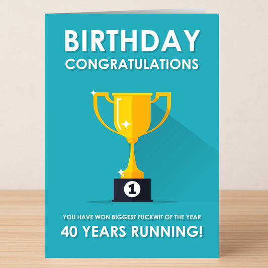 Celebrate their milestone with Twisted Gifts' "40 - Running 40 Insulting Birthday Card." This turquoise card features a gold "1" trophy and reads: "BIRTHDAY CONGRATULATIONS. You have won biggest fuckwit of the year 40 years running!.