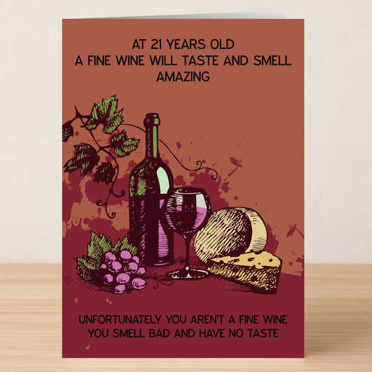 The Twisted Gifts 21 - Fine Wine 21 Insulting Birthday Card features a wine bottle, glass, cheese, and grapes with a joke comparing turning 21 to fine wine—smells bad and has no taste!.
