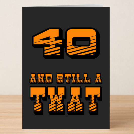 The Twisted Gifts "40 - Still A Twat 40 Insulting Birthday Card" features bold orange text on black, reading "40 AND STILL A TWAT." It's the perfect funny and insulting card for a 40th birthday.