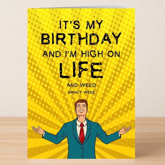 The "High On Life Funny Birthday Card" by Twisted Gifts features a man in a blue suit on a yellow dotted background with the caption: "It's my birthday and I'm high on life and weed, mainly weed.