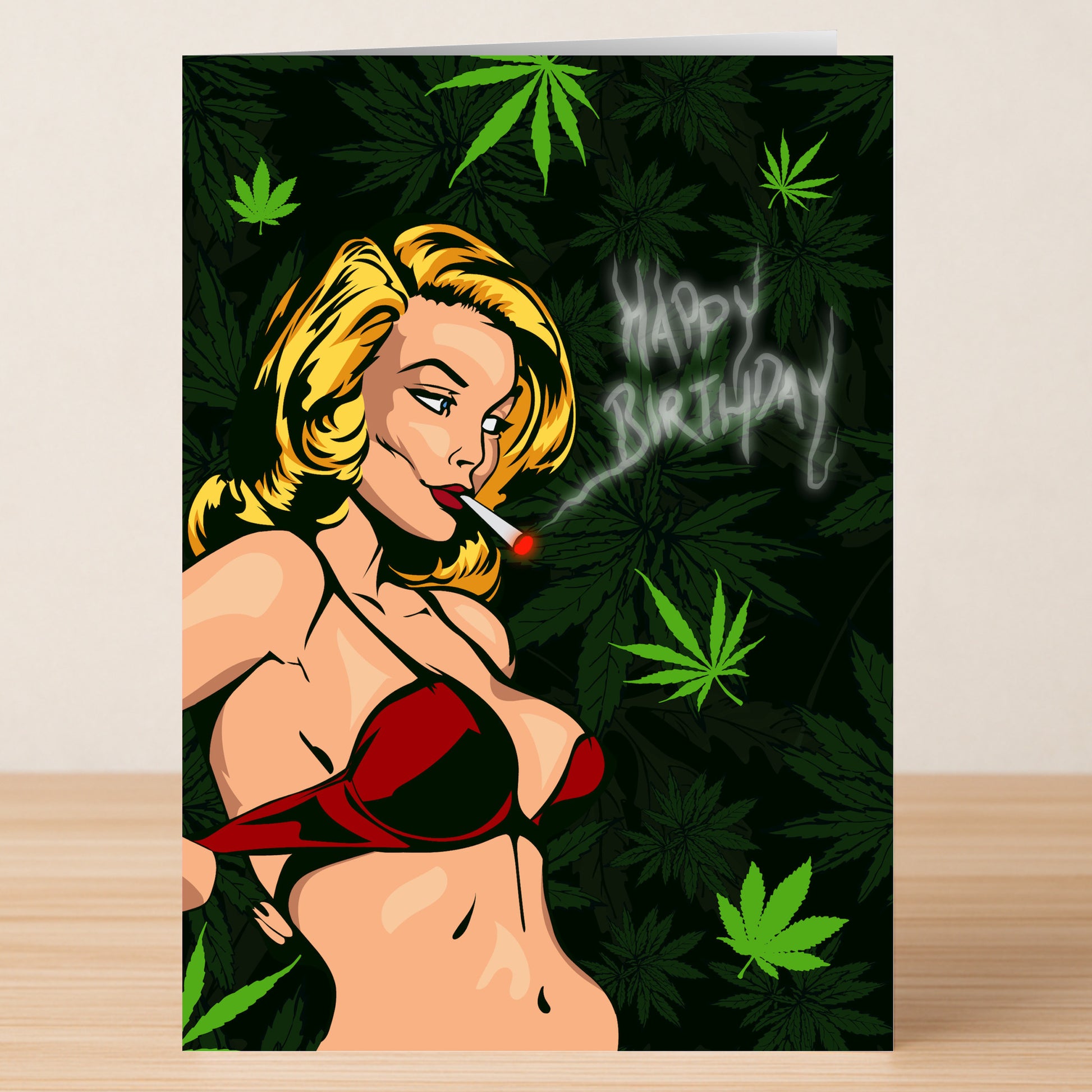 Twisted Gifts' Weed Funny Birthday Card features a woman in a red bikini smoking, marijuana leaves in the background, and "Happy Birthday" spelled out in smoke—perfect for any cannabis lover.