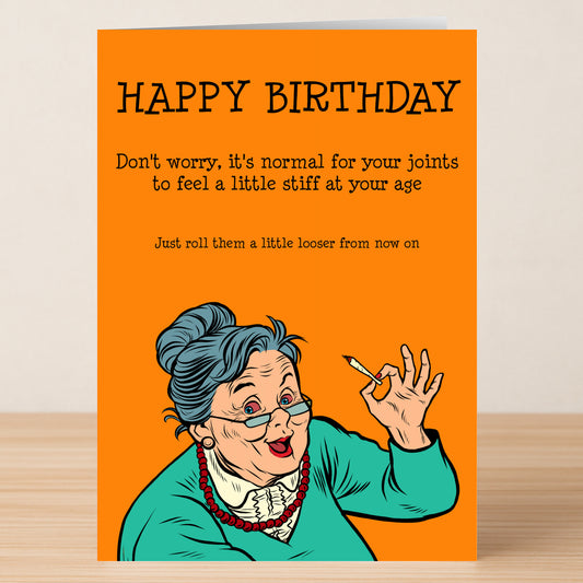 Celebrate with laughter! The Stiff Joints Funny Birthday Card by Twisted Gifts features "HAPPY BIRTHDAY," an illustration of an older woman with a cigarette, and a witty joke about aging and stiff joints.