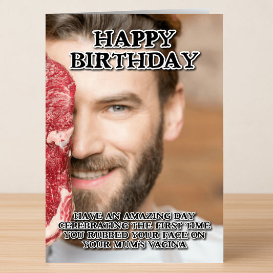 A man smiles while holding a raw steak to his face. Text reads, "Happy Birthday." Celebrate with Twisted Gifts' Face Rub Rude Birthday Card—humor for those who love a comical, original birthday message!.