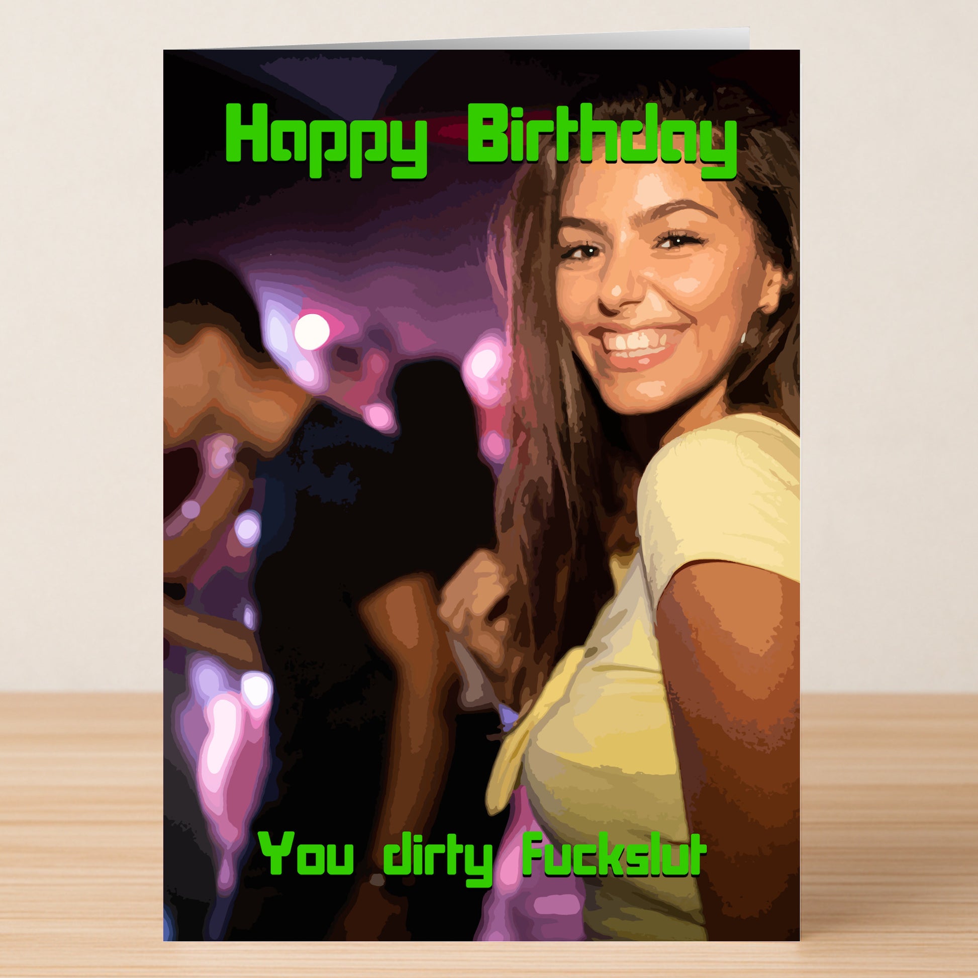 A woman smiles at a neon-lit party. Green text reads "Happy Birthday" and "You dirty fuckslut," showcasing Twisted Gifts' Fuck Slut Insulting Birthday Card—a bold, no-nonsense, and unique birthday message.
