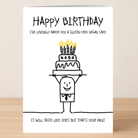 The Twisted Gifts "GFV Cake Insulting Birthday Card" features a stick figure with a cake and the funny message: "I've lovingly baked you a gluten free vegan cake. It will taste like shit. But that's your fault." Perfect for birthdays!.