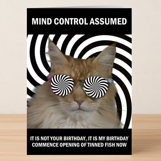 The Mind Control Funny Birthday Card by Twisted Gifts features a cat in spiral sunglasses before a hypnotic backdrop, reading: "MIND CONTROL ASSUMED—IT IS MY BIRTHDAY. COMMENCE OPENING OF TINNED FISH NOW." Perfect for cat lovers!.
