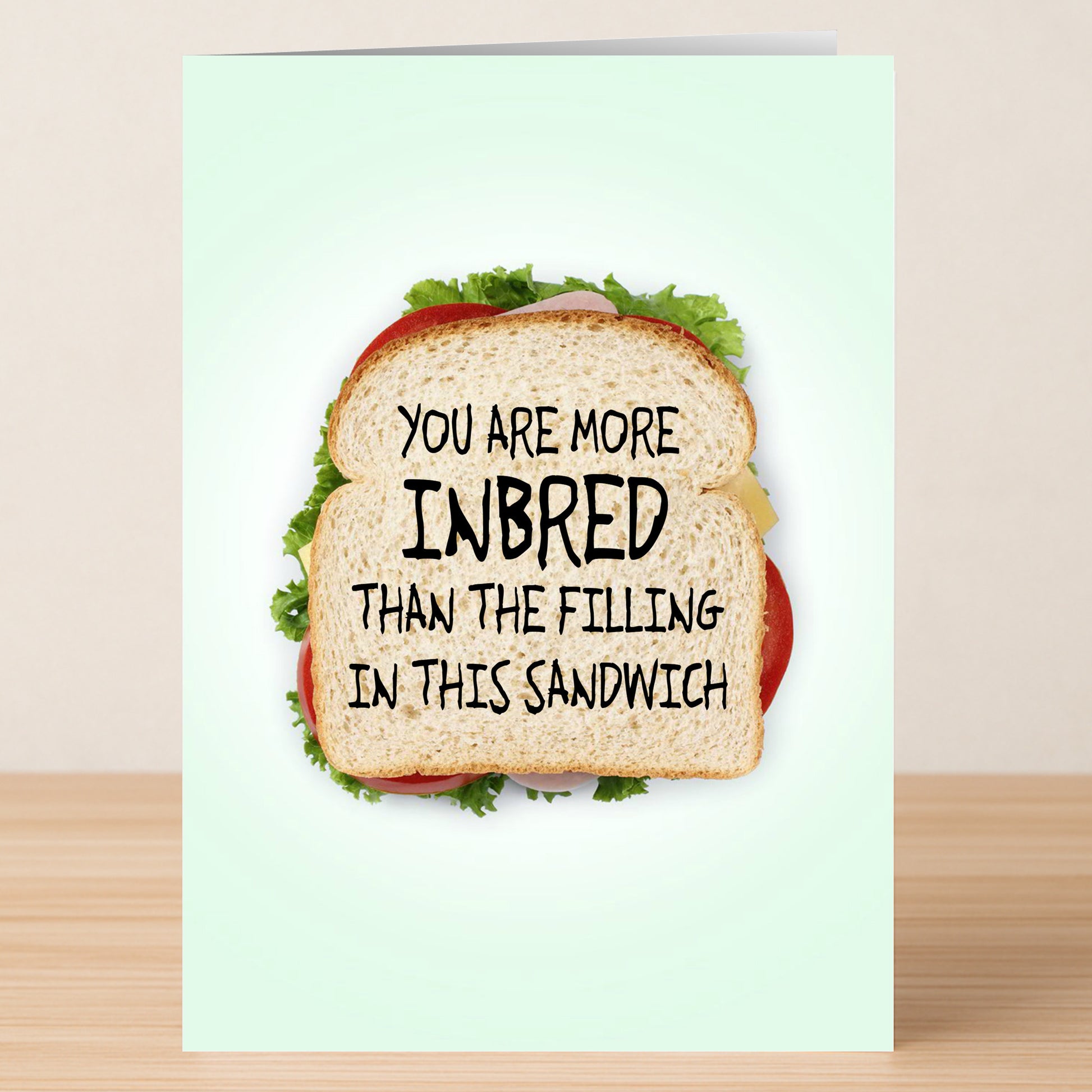 The Inbread Funny Birthday Card by Twisted Gifts features a sandwich and the joke "You are more inbred than the filling in this sandwich." It's a hilarious way to make someone's birthday extra special!.