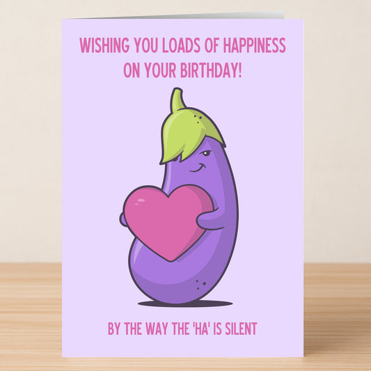 Twisted Gifts' Silent HA Funny Birthday Card shows a cartoon eggplant holding a pink heart with "Wishing you loads of happiness on your birthday!" above and "By the way the 'ha' is silent." below, plus a humorous message inside.