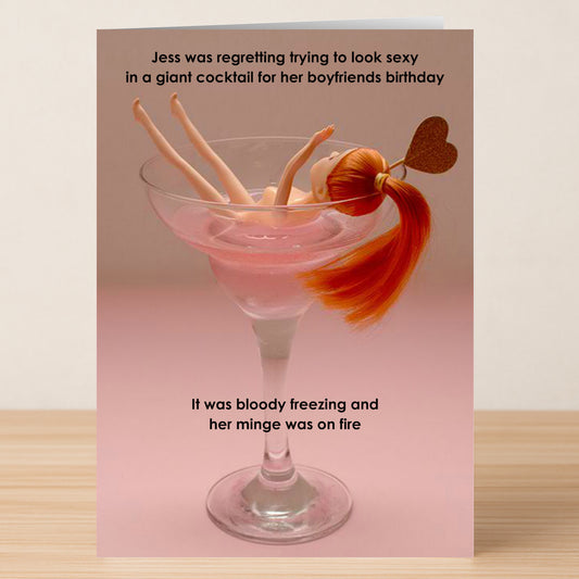 The Giant Cocktail Funny Birthday Card by Twisted Gifts features a doll upside down in a huge drink, with humorous text about regretting trying to look sexy for your boyfriend's birthday.