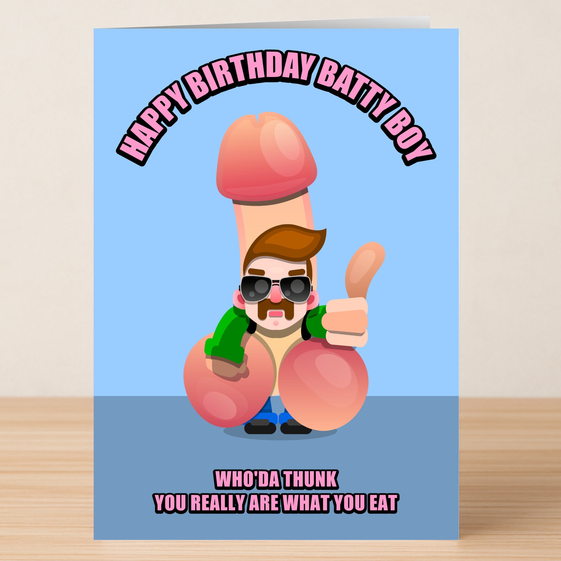 The Batty Boy Rude Birthday Card from Twisted Gifts features a cartoon man with sunglasses and beard humorously illustrated as a penis, with the message, "Happy Birthday Batty Boy" above and "Who'da thunk you really are what you eat," below.