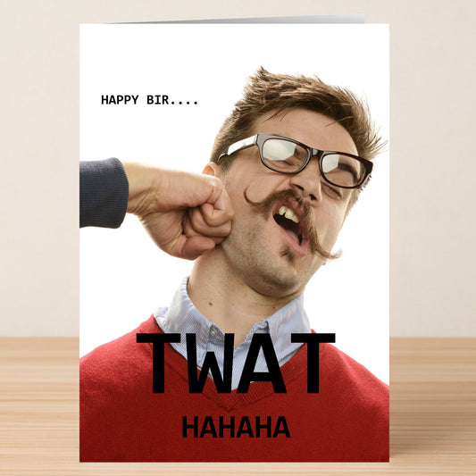 Twisted Gifts’ Twat HaHa Funny Birthday Card features a person with glasses and mustache getting punched and the text "HAPPY BIR... TWAT HAHAHA"—a hilarious, cheeky card for those who enjoy irreverent birthday humor!.