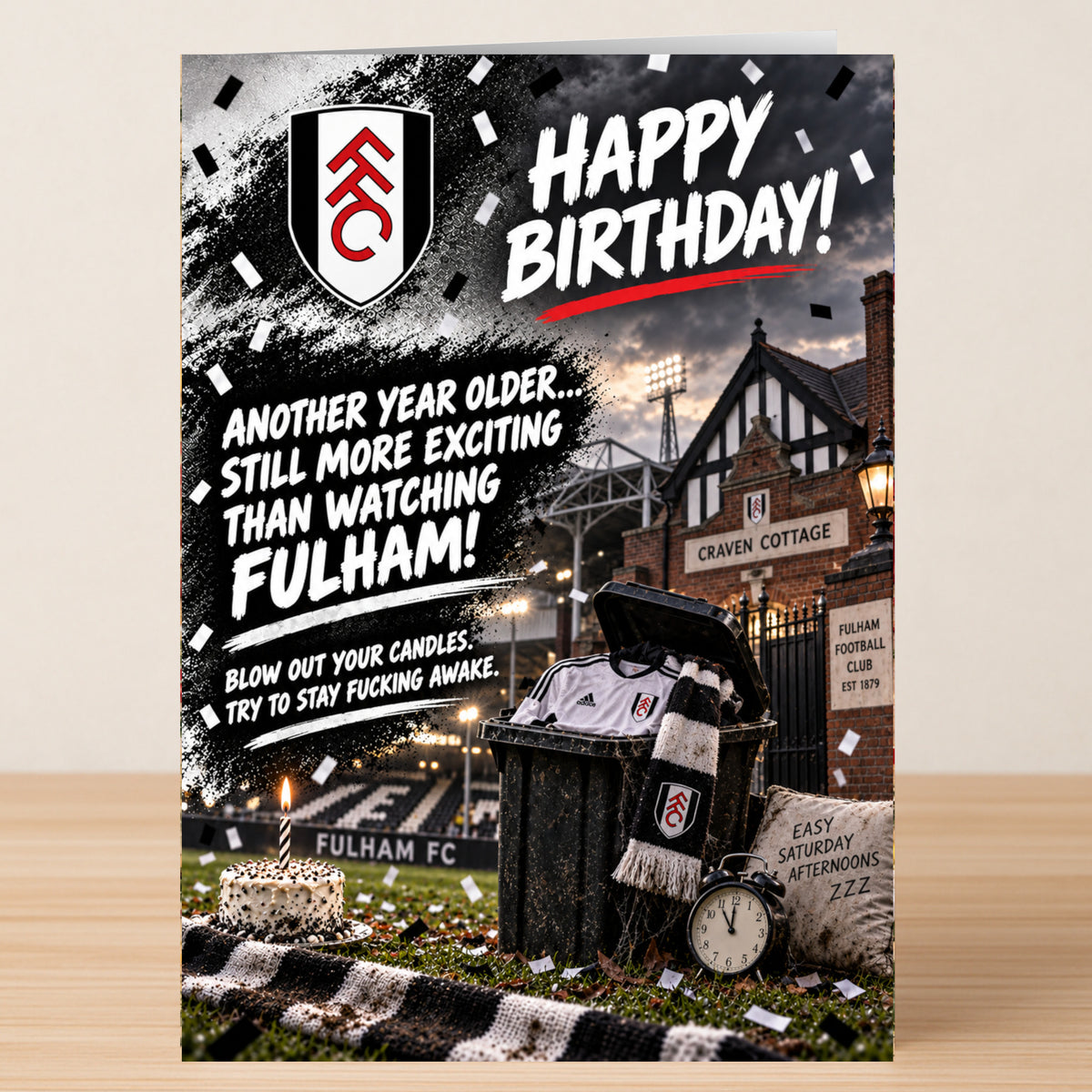 A Fulham – Funny Birthday Card featuring a stadium scene with a discarded jersey, a scarf, a cake, and text reading: “Happy Birthday! Another year older... still more exciting than watching Fulham!”.