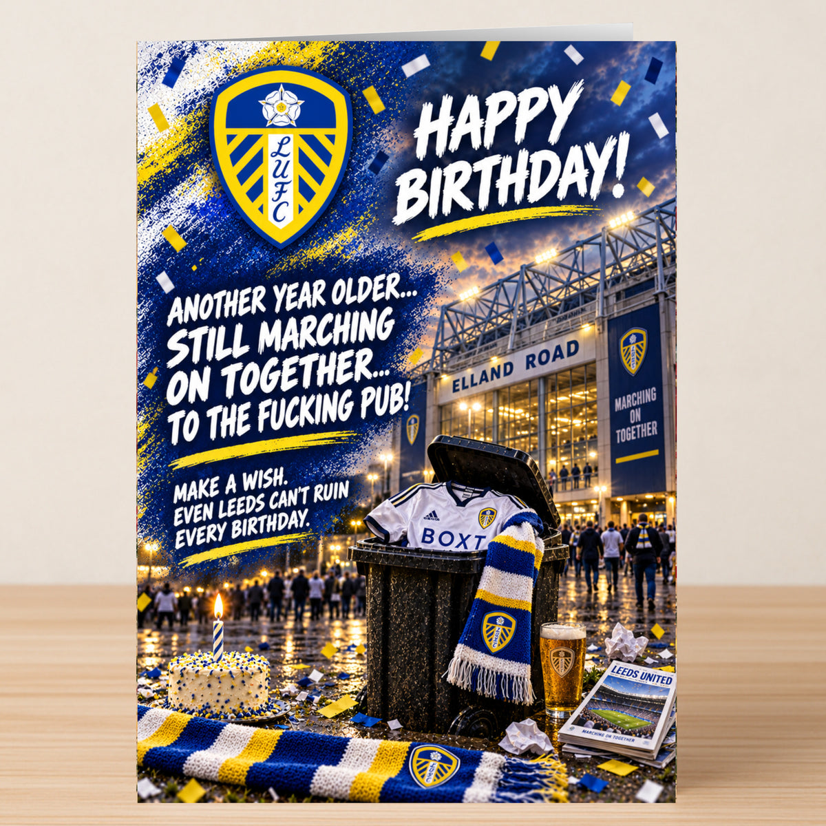 Leeds United – Funny Birthday Card featuring the team crest, a stadium, and a trash can with a jersey, scarf, and beer, with the text: “Happy Birthday! Another year older... still marching on together.”