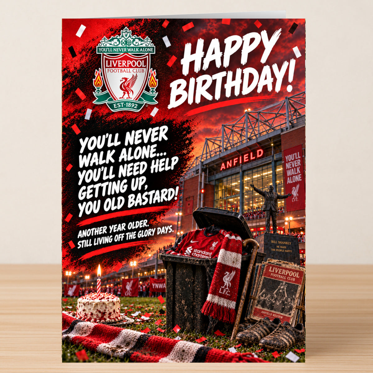 Liverpool – Funny Birthday Card featuring Anfield, a red-and-white scarf, and a cake, with the text: “Happy Birthday! You’ll never walk alone... you’ll need help getting up, you old bastard!”.