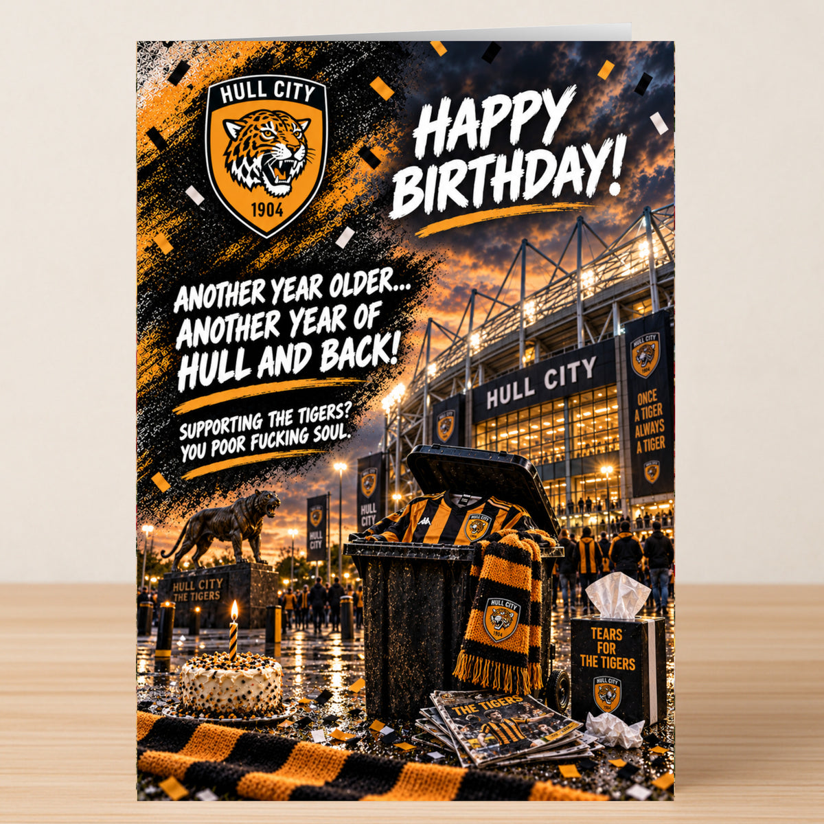 A Hull City – Funny Birthday Card featuring the stadium, a tiger statue, a cake, and team accessories, with the text “Happy Birthday! Another year older... Another year of Hull and back!”.