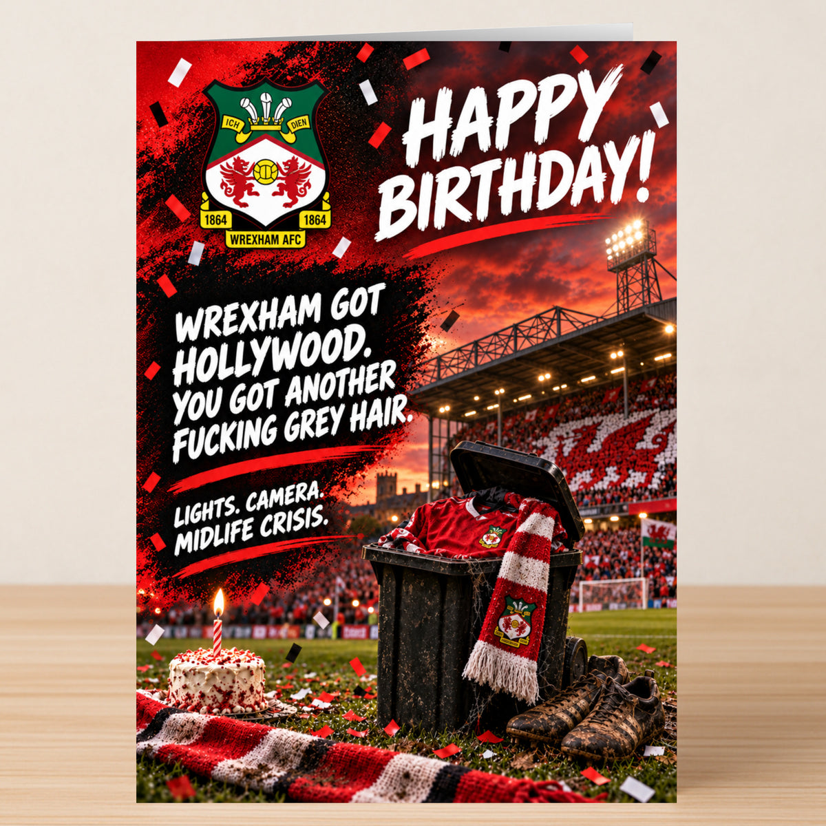 Wrexham AFC – Funny Birthday Card featuring the team logo and a stadium backdrop, with the text: “Happy Birthday! Wrexham got Hollywood. You got another fucking grey hair. Lights. Camera. Midlife crisis.”