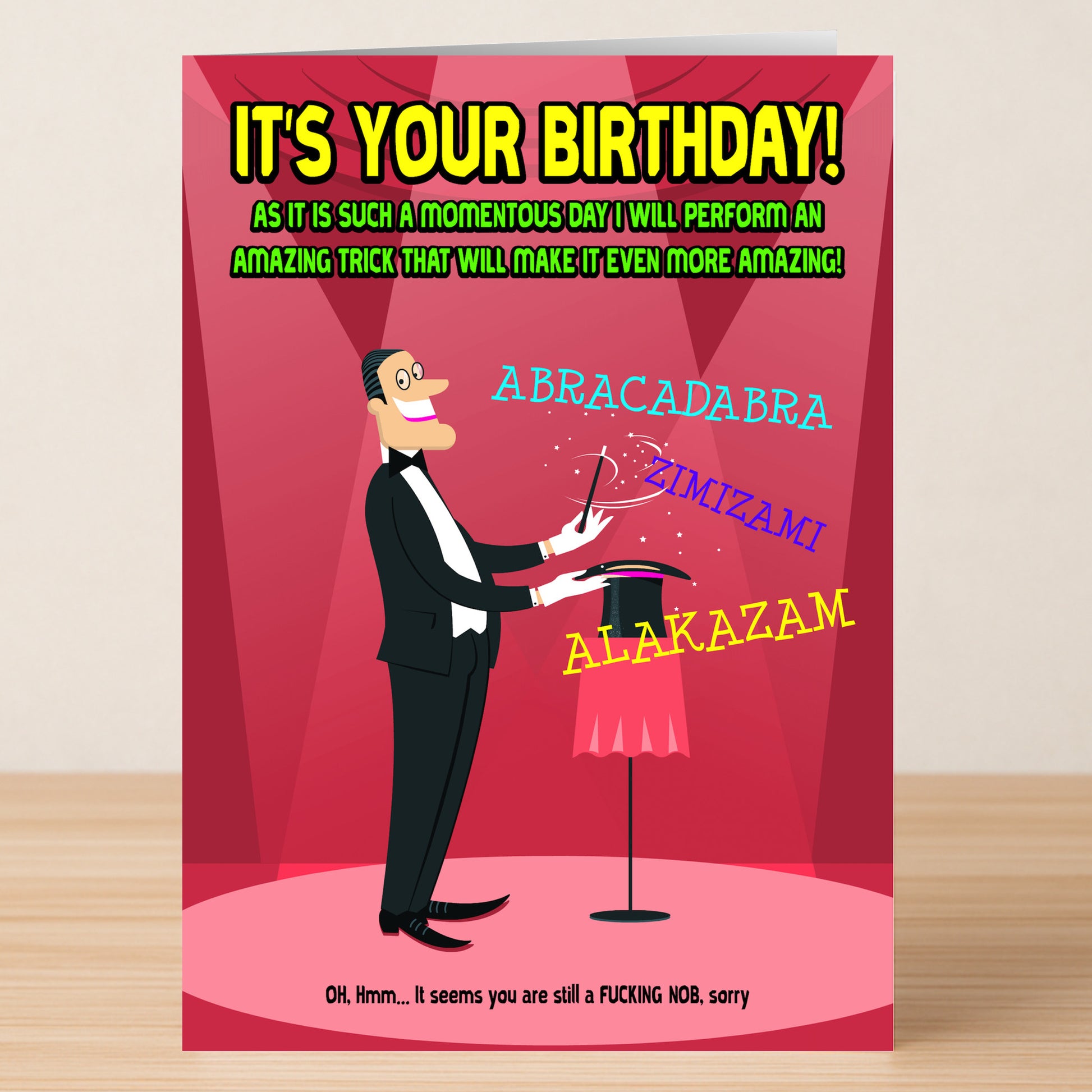 A cartoon magician from Twisted Gifts' Magic Insulting Birthday Card performs tricks with words like "ABRACADABRA!" and bold text shouts, "IT'S YOUR BIRTHDAY!"—the perfect sarcastic humor for any birthday.