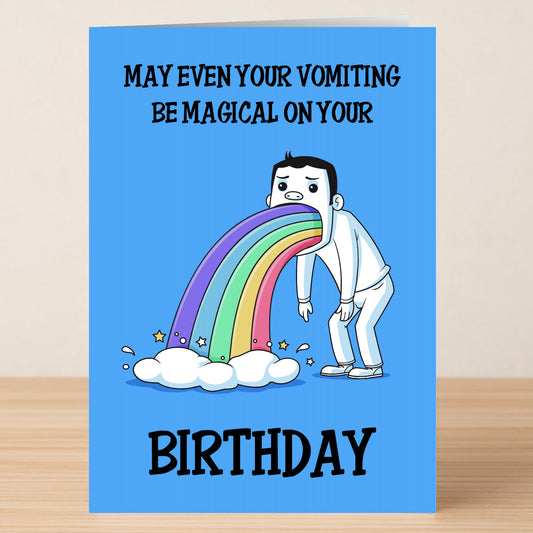 The Magical Funny Birthday Card by Twisted Gifts features a cartoon vomiting a rainbow and stars onto a cloud, with the message "May even your vomiting be magical on your birthday." A fun pick for those who love humor and whimsy!.
