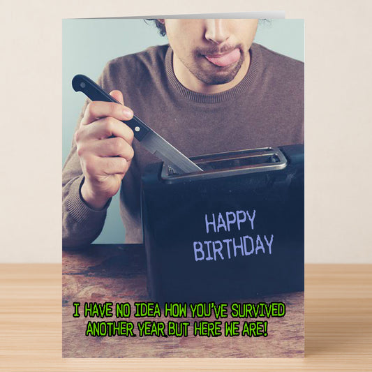 On the Twisted Gifts "Another Year Insulting Birthday Card," a man jokily readies a knife for the toaster with "HAPPY BIRTHDAY" and "I have no idea how you’ve survived another year but here we are!" on the cover—sure to inspire laughs!.