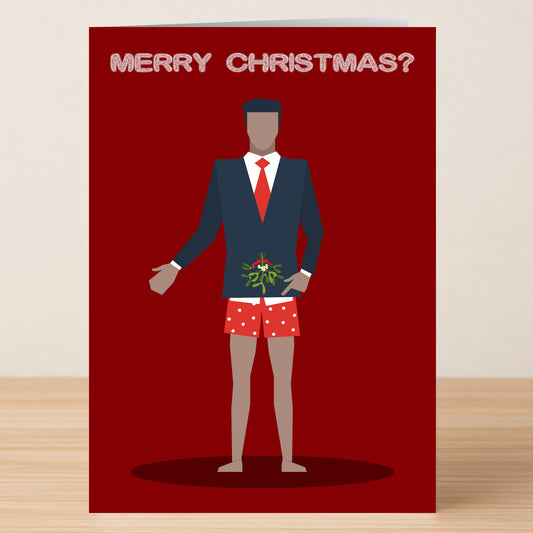 The Merry Christmas Rude Christmas Card by Twisted Gifts features a suited man with a red tie and polka-dot boxers holding mistletoe, "Merry Christmas?" above him—a cheeky holiday card great for festive laughs.