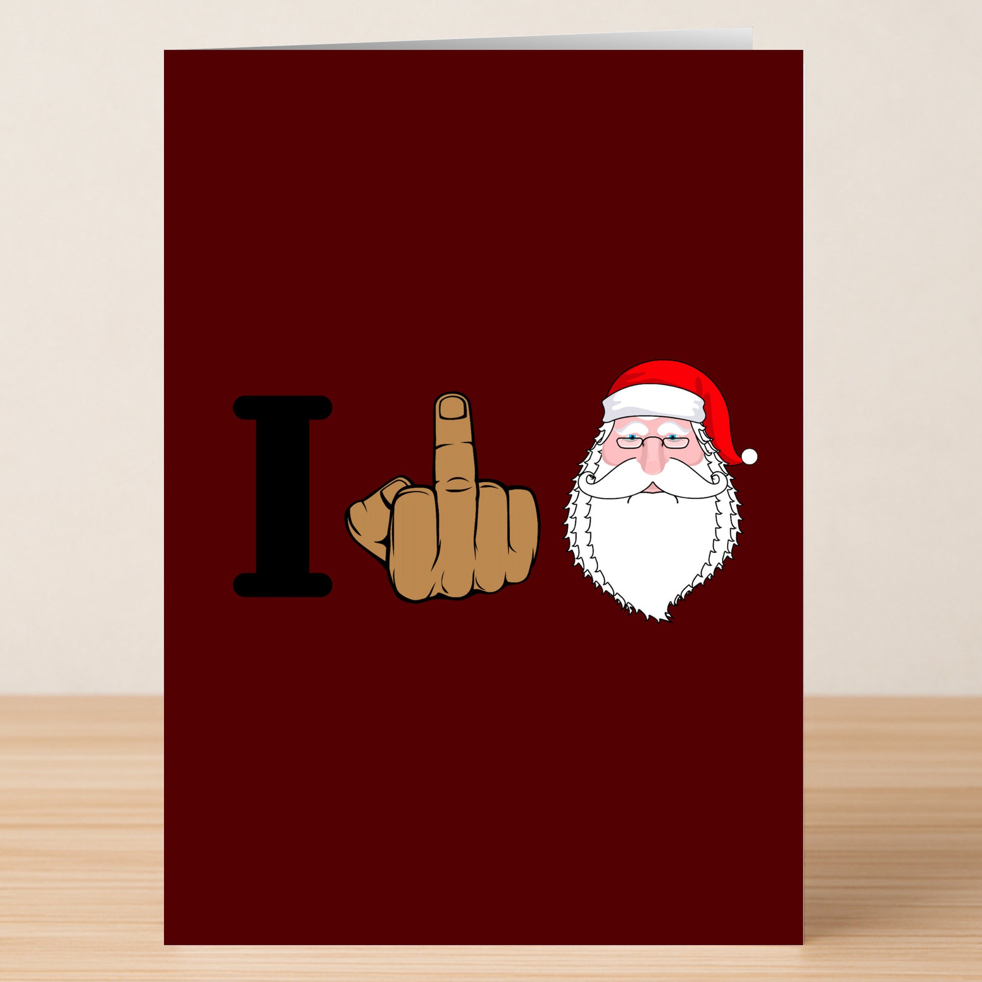 The I Love Xmas Funny Christmas Card by Twisted Gifts features a red background with the letter "I," a raised middle finger, Santa's face, and delivers a cheeky twist on holiday cheer.