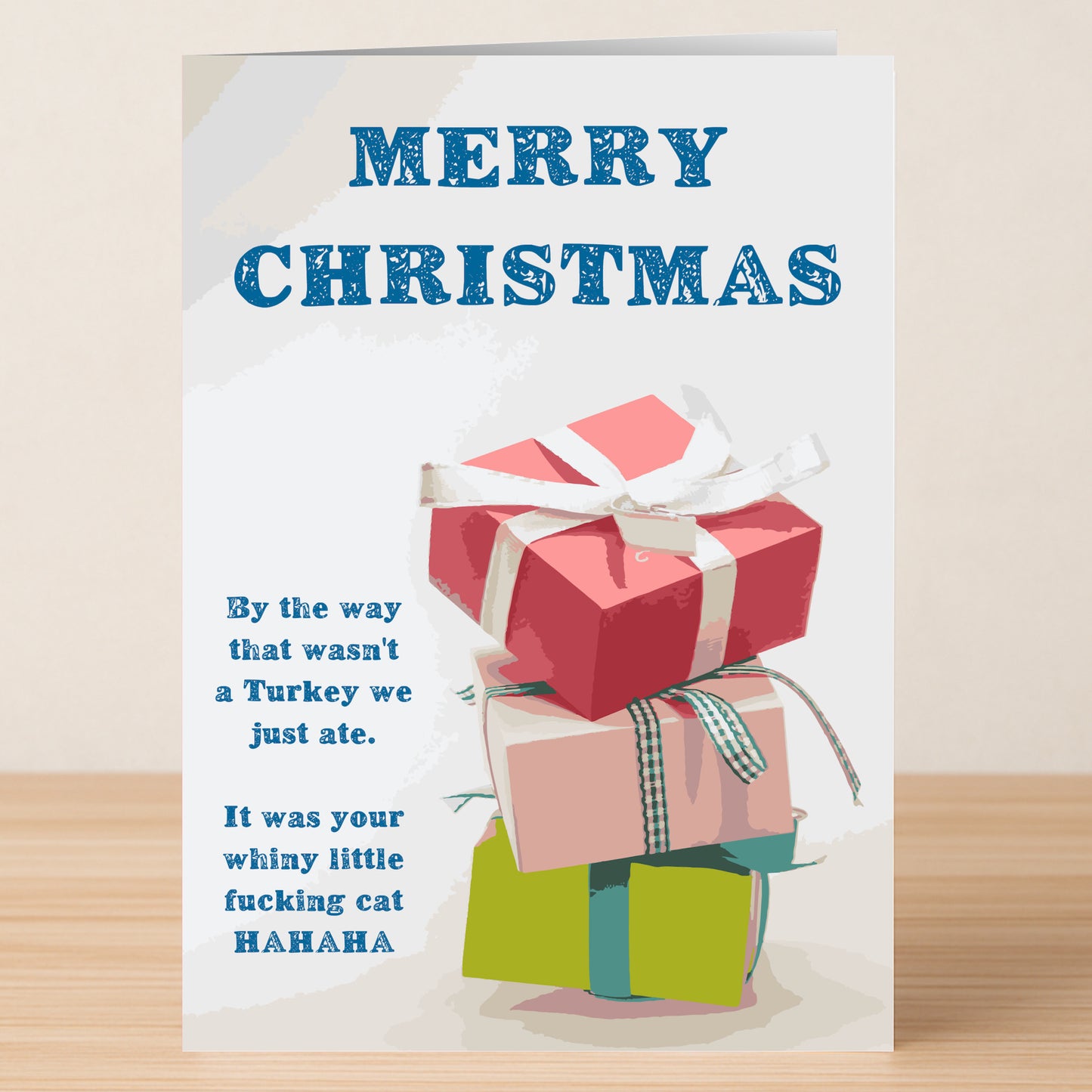 The Twisted Gifts “Wasn't A Turkey, Was A Cat” Funny Christmas Card features three stacked gift boxes and a witty, irreverent message—perfect for anyone who loves a laugh with their holiday greetings.