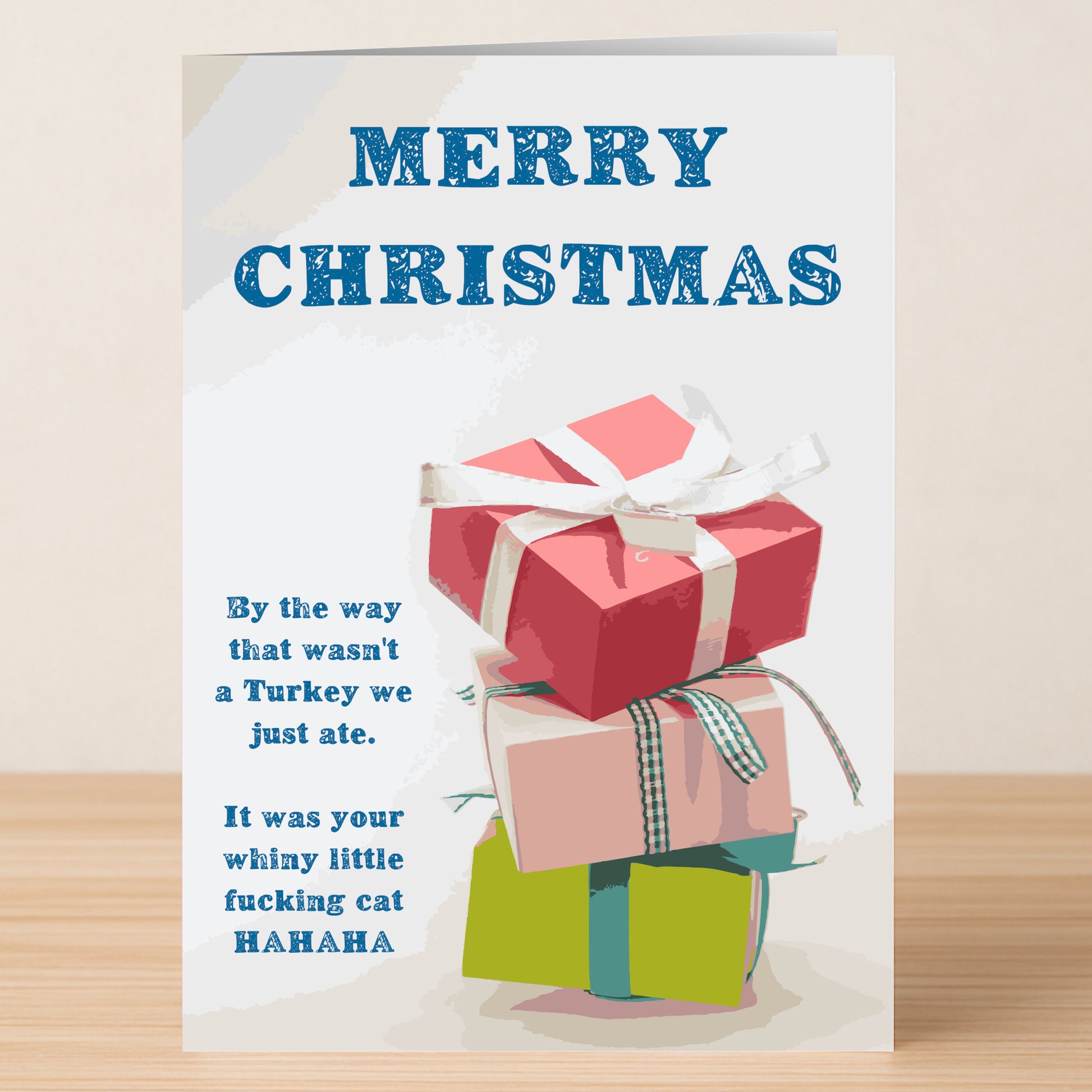 The Twisted Gifts “Wasn't A Turkey, Was A Cat” Funny Christmas Card features three stacked gift boxes and a witty, irreverent message—perfect for anyone who loves a laugh with their holiday greetings.