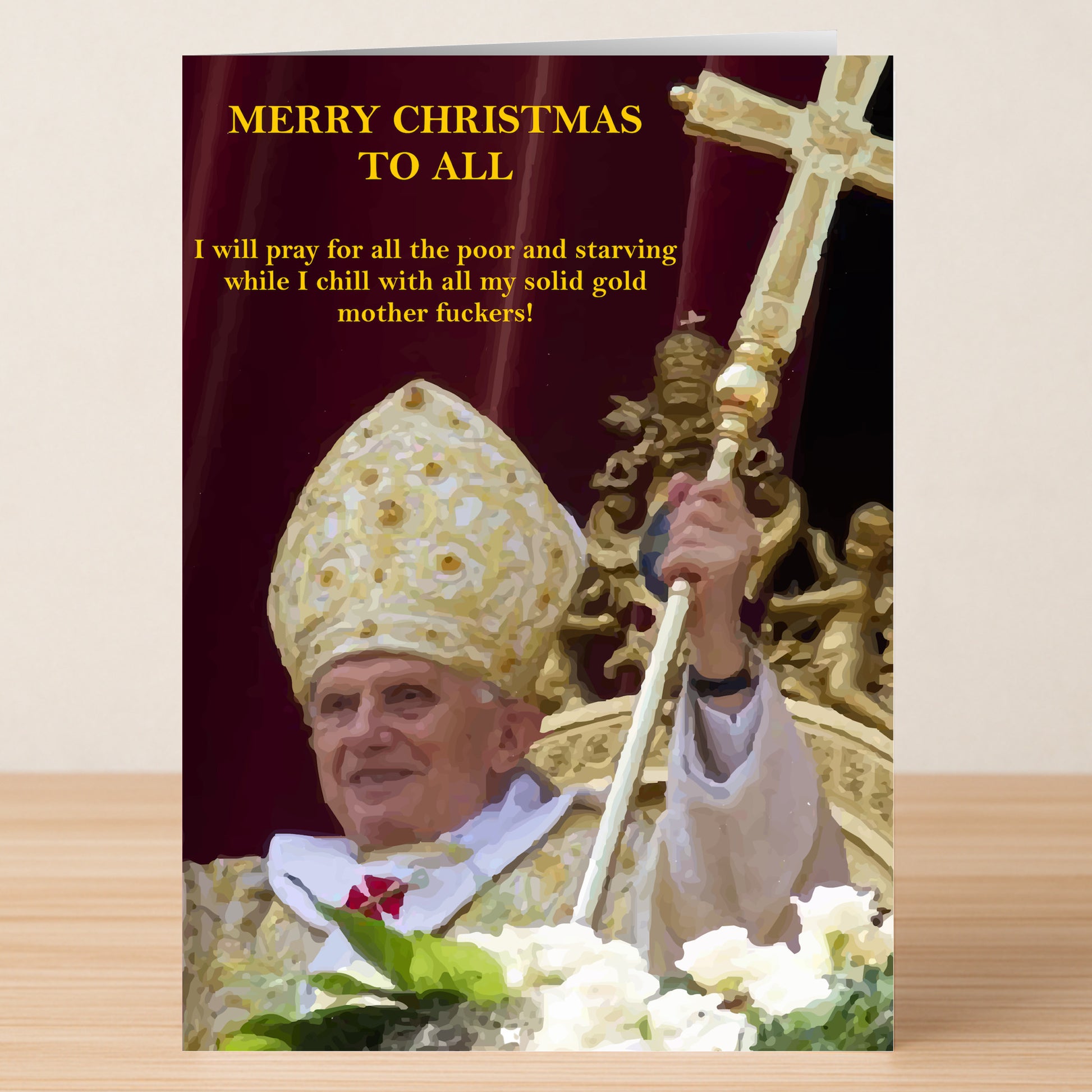 A Solid Gold Rude Christmas Card by Twisted Gifts shows a religious leader in gold vestments holding a staff, raising his hand with a bold yellow satirical holiday message above and beside him.
