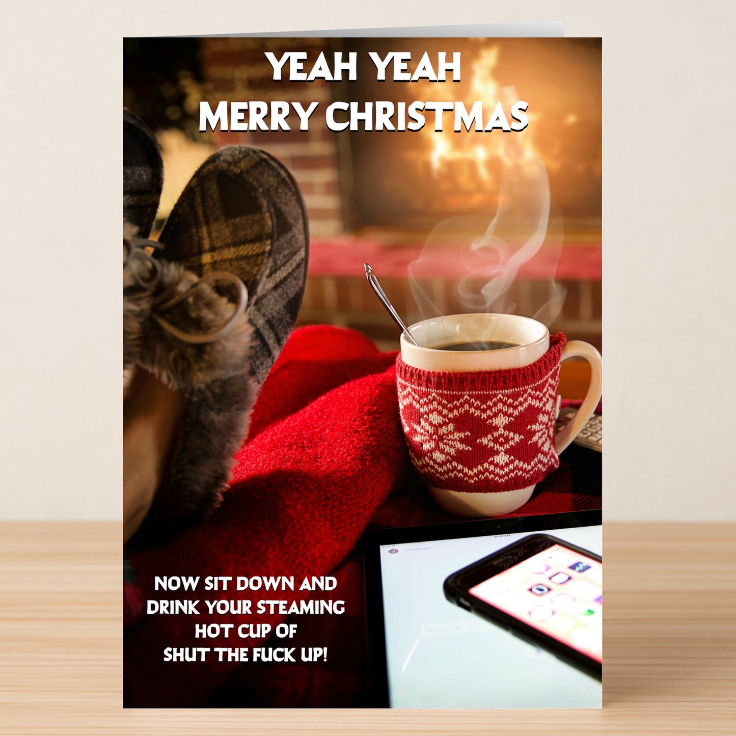 Spread festive laughs with the Shut Up Rude Christmas Card from Twisted Gifts! Featuring a cozy holiday scene, its bold message reads: "YEAH YEAH MERRY CHRISTMAS. NOW SIT DOWN AND DRINK YOUR STEAMING HOT CUP OF SHUT THE FUCK UP!.