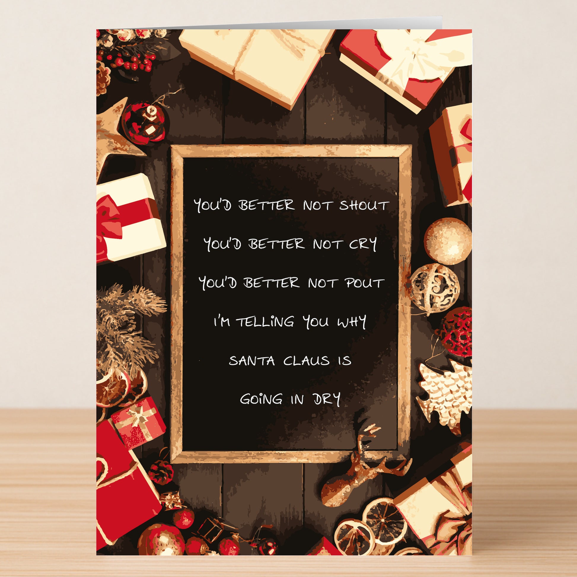 The Santa Dry Rude Christmas Card by Twisted Gifts features a funny chalkboard illustration with the lyrics, "You'd better not shout...Santa Claus is going in dry," surrounded by festive Christmas cheer.