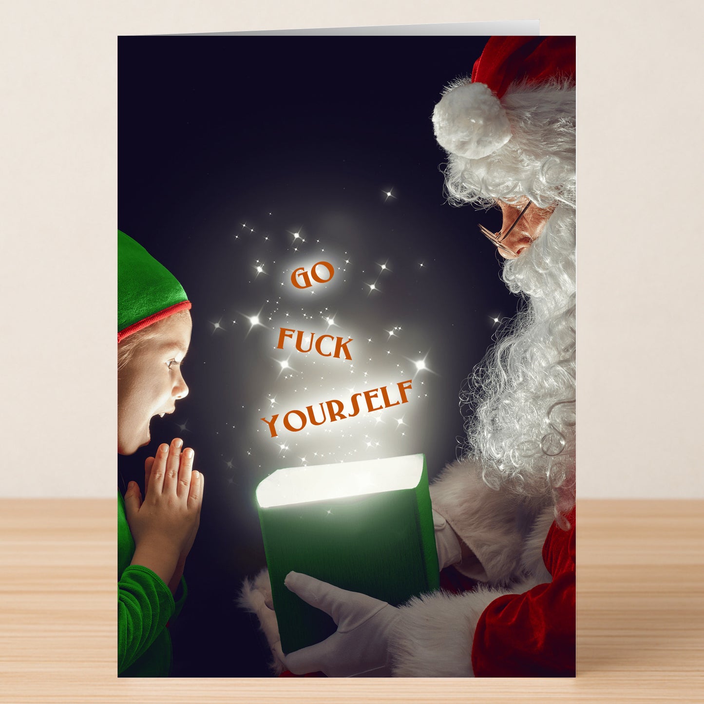 Santa presents a green box to a surprised child as glowing words "GO FUCK YOURSELF" appear—Twisted Gifts' Fuck Yourself Funny Christmas Card delivers unexpected holiday cheer in a hilarious, bold design.
