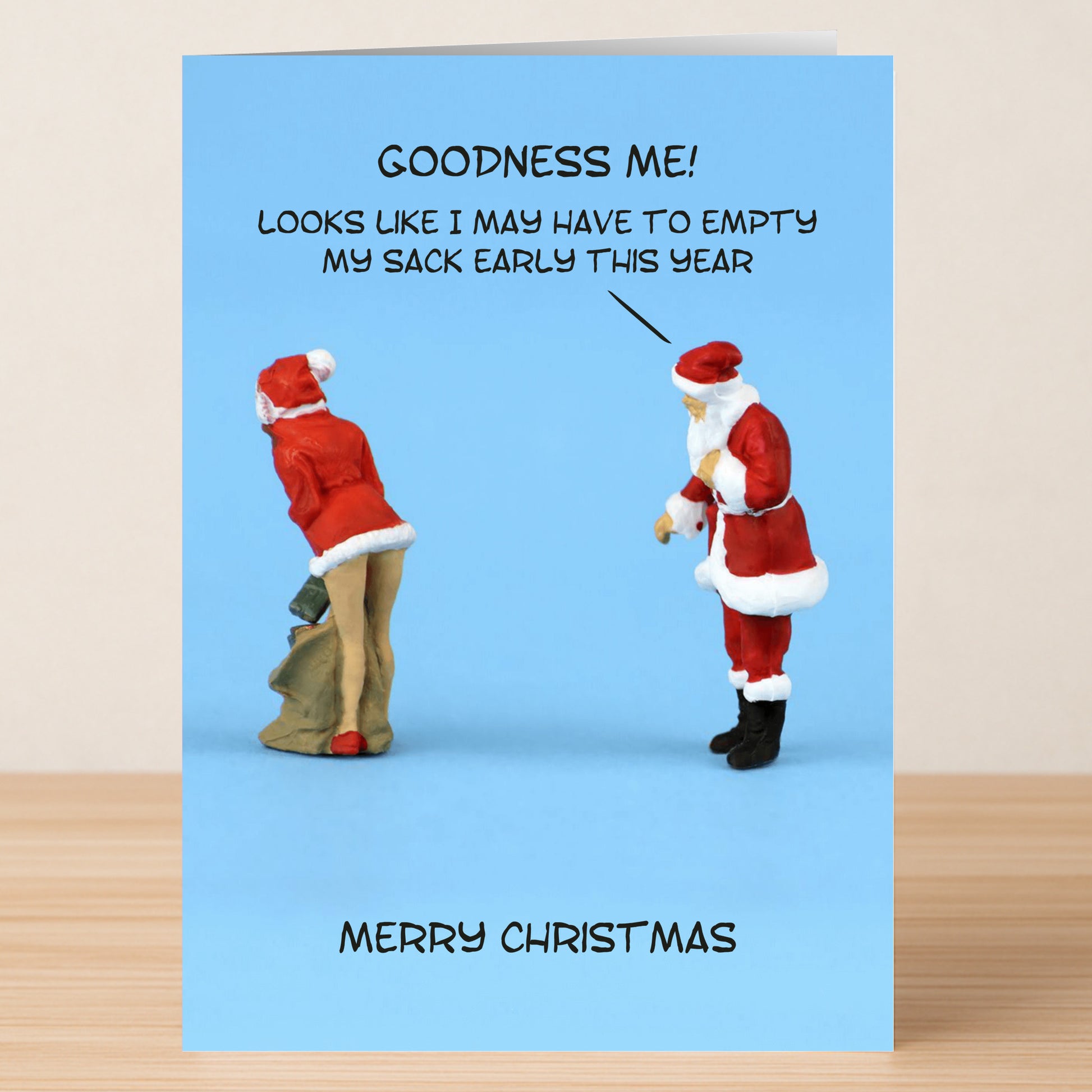 The Early Rude Christmas Card by Twisted Gifts features Santa ogling a woman in a Santa outfit with the cheeky caption, "Goodness me! Looks like I may have to empty my sack early this year." A funny holiday card!.
