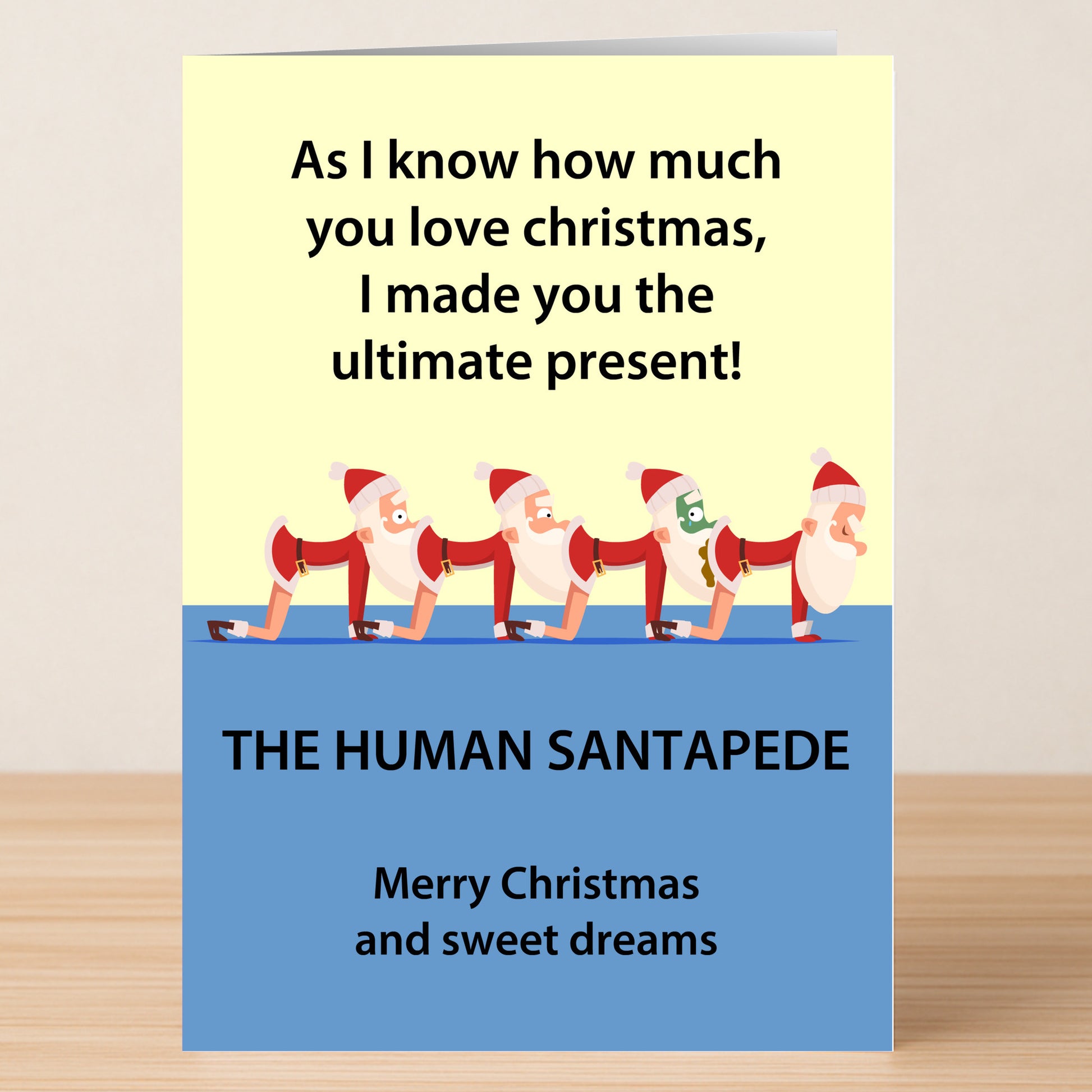 The Santapede Rude Christmas Card by Twisted Gifts features cartoon Santas in a cheeky "Human Centipede"-inspired design with witty text, printed on high-quality paper—a unique and humorous Christmas present.