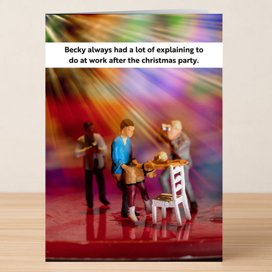The Explaining Rude Christmas Card by Twisted Gifts features three mini figurines at an office Christmas party, one slumped over a chair, humorously capturing the aftermath: "Becky always had a lot of explaining to do at work after the party.