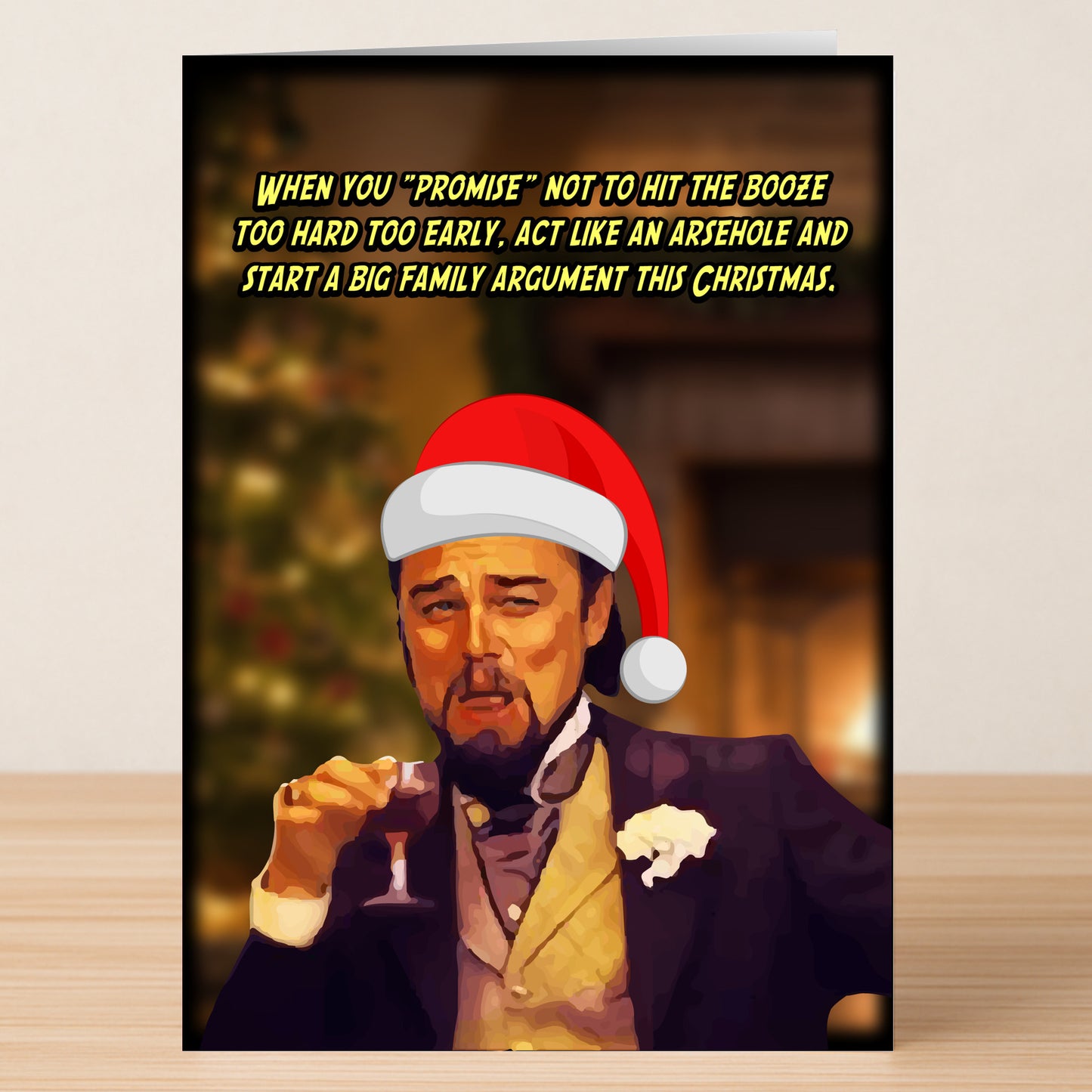 The Family Argument Funny Christmas Card by Twisted Gifts features a witty design of a man in a suit and Santa hat with a drink, joking about starting family arguments over the holidays.